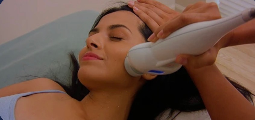 Client receiving a cryo facial with cool vapor applied to the face