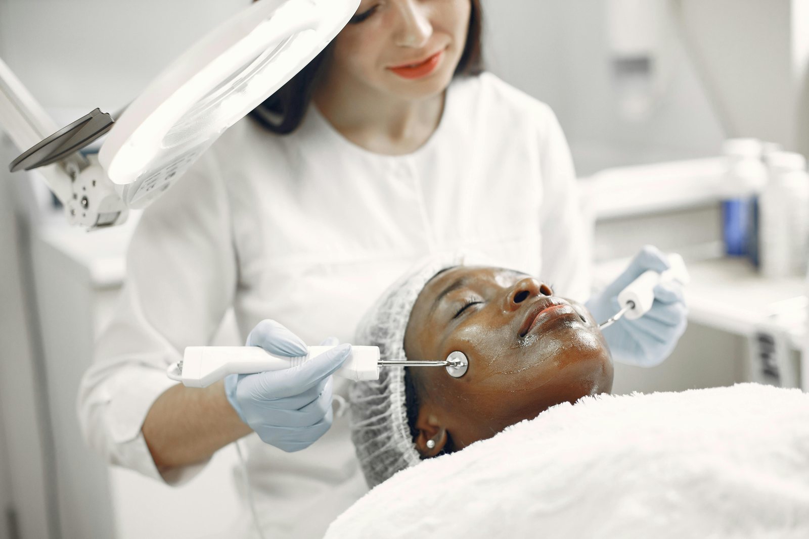 Client receiving a microchanneling treatment with a handheld device
