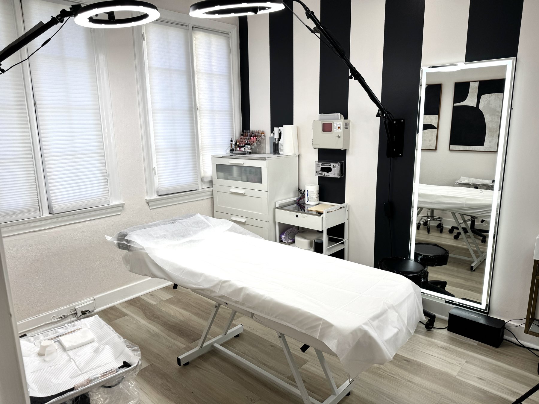 Treatment room at Elevate You Studio with a covered table and warm lighting